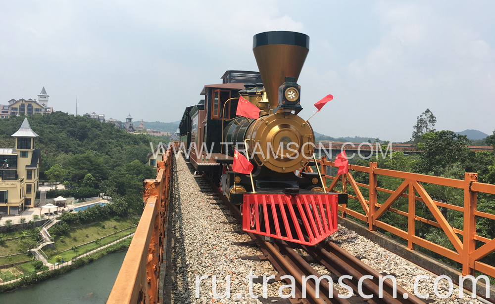 sightseeing train red and yellow colours on bridge